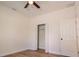 Bright bedroom features wood-look floors, ceiling fan, closet and neutral paint at 8317 N Ogontz Ave, Tampa, FL 33604