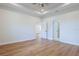 Bright, spacious bedroom featuring a tray ceiling and light wood-look flooring at 8317 N Ogontz Ave, Tampa, FL 33604