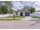 Charming home featuring a gray garage door, red front door and well-maintained green lawn at 8317 N Ogontz Ave, Tampa, FL 33604