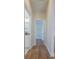 Hallway shot showing the view to a bathroom and bedroom with wood-look floors at 8317 N Ogontz Ave, Tampa, FL 33604