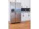 Stainless steel refrigerator stands next to white cabinets and granite countertops in this modern kitchen at 8317 N Ogontz Ave, Tampa, FL 33604