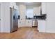 Modern kitchen with white cabinets, stainless steel appliances, granite countertops, and stylish backsplash at 8317 N Ogontz Ave, Tampa, FL 33604