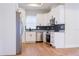 Modern kitchen with white cabinets, stainless steel appliances, granite countertops, and stylish backsplash at 8317 N Ogontz Ave, Tampa, FL 33604