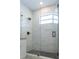 Modern tiled shower featuring a glass door, matte black fixtures and dark mosaic flooring at 8317 N Ogontz Ave, Tampa, FL 33604