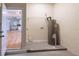 Utility room features a modern Rheem water heater with easy access to the kitchen with sleek white cabinetry at 8317 N Ogontz Ave, Tampa, FL 33604