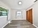 Bedroom with vinyl flooring, windows, and wood closet doors at 11185 104Th St, Largo, FL 33773