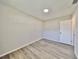 Well-lit bedroom with vinyl flooring and a white door at 11185 104Th St, Largo, FL 33773