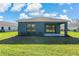 Home with covered patio and grassy backyard at 13584 Old Creek Ct, Parrish, FL 34219