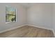Bright bedroom with wood-look floors and window coverings at 13584 Old Creek Ct, Parrish, FL 34219