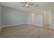 Spacious bedroom with wood-look floors and ceiling fan at 13584 Old Creek Ct, Parrish, FL 34219