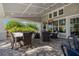Relaxing community patio with covered seating area and outdoor dining furniture at 13584 Old Creek Ct, Parrish, FL 34219