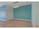 Dining area with light wood floors and blue accent wall at 13584 Old Creek Ct, Parrish, FL 34219