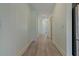 Light-colored hallway with wood-look flooring at 13584 Old Creek Ct, Parrish, FL 34219