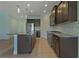Modern kitchen with stainless steel appliances and dark cabinets at 13584 Old Creek Ct, Parrish, FL 34219
