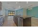 Kitchen with island, granite countertops, and view to living room at 13584 Old Creek Ct, Parrish, FL 34219
