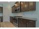 Modern kitchen with stainless steel appliances and dark cabinets at 13584 Old Creek Ct, Parrish, FL 34219