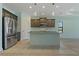Modern kitchen with island and stainless steel appliances at 13584 Old Creek Ct, Parrish, FL 34219
