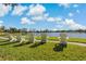 Scenic community lake view with Adirondack chairs and lush green space at 13584 Old Creek Ct, Parrish, FL 34219