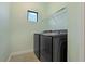 Laundry room with washer, dryer, and shelving at 13584 Old Creek Ct, Parrish, FL 34219