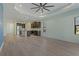 Open living room and kitchen with wood-look floors at 13584 Old Creek Ct, Parrish, FL 34219