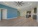 Open living room and kitchen with wood-look floors at 13584 Old Creek Ct, Parrish, FL 34219