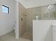Large walk-in shower with tile surround and glass door at 13584 Old Creek Ct, Parrish, FL 34219