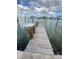 Wooden dock on calm water with a platform at 14045 E Parsley Dr, Madeira Beach, FL 33708