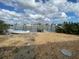 Boat and dock at waterfront property with view of other houses across the water at 14045 E Parsley Dr, Madeira Beach, FL 33708