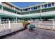 Private patio with seating area and view of building at 141 94Th Ave, Treasure Island, FL 33706