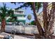 Side yard with white fence and view of neighboring building at 141 94Th Ave, Treasure Island, FL 33706