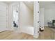 Light-filled hallway with hardwood floors, leading to bedrooms and stairs at 1908 E 17Th Ave, Tampa, FL 33605