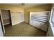 Vacant bedroom featuring built-in shelving, patterned flooring, and a closet at 2509 Hollis Dr, Tampa, FL 33618