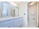 Bright bathroom features vanity with drawers, decorative mirror and glass-enclosed shower at 270 Michaels Cir, Oldsmar, FL 34677