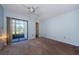 Bright bedroom featuring a ceiling fan, carpeted floors, and sliding door to patio at 270 Michaels Cir, Oldsmar, FL 34677