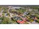 Aerial view of a house with solar panels and a pool, situated in a residential neighborhood at 2711 Brattle Ln, Clearwater, FL 33761