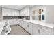 Modern white kitchen with gray countertops and stainless steel appliances at 2711 Brattle Ln, Clearwater, FL 33761