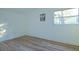 Simple bedroom with wood-look floors and window at 290 13Th N Ave, Safety Harbor, FL 34695