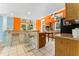 Modern kitchen with breakfast bar and orange and blue accents at 35 Deerpath Dr, Oldsmar, FL 34677