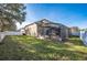 Spacious backyard with screened enclosure and grassy area at 3602 Juneberry Dr, Wesley Chapel, FL 33543