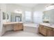 Bathroom with double vanity, large soaking tub, and window at 3602 Juneberry Dr, Wesley Chapel, FL 33543