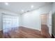 Bright bedroom with hardwood floors and access to another room at 3602 Juneberry Dr, Wesley Chapel, FL 33543