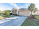 Tan house with a two-car garage and driveway at 3602 Juneberry Dr, Wesley Chapel, FL 33543