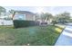Landscaped yard with a one-story house and palm tree at 3602 Juneberry Dr, Wesley Chapel, FL 33543