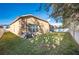 Tan house exterior with AC units and fenced yard at 3602 Juneberry Dr, Wesley Chapel, FL 33543