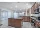 Island kitchen with granite countertops and stainless steel appliances at 3602 Juneberry Dr, Wesley Chapel, FL 33543