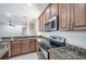 Kitchen boasts granite counters and stainless steel appliances at 3602 Juneberry Dr, Wesley Chapel, FL 33543