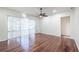Hardwood floor living room with ceiling fan and sliding doors at 3602 Juneberry Dr, Wesley Chapel, FL 33543