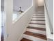 Elegant wooden staircase with white railing at 3602 Juneberry Dr, Wesley Chapel, FL 33543
