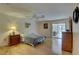 Spacious bedroom featuring hardwood floors, ceiling fan and a glass sliding door to the sunroom at 3703 Quail Hollow Pl, Bradenton, FL 34210