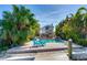 Pool and patio area with waterfront access and tropical landscaping at 410 140Th E Ave, Madeira Beach, FL 33708